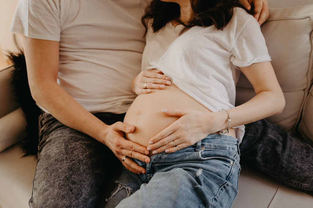 Detal z domowej sesji ciażowej. Przyszła mama na sesji brzuszkowej w domu, w Gdańsku, wraz z partnerem